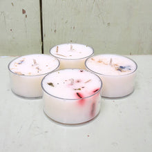 Load image into Gallery viewer, Four small candles with decorative elements on a light wooden surface