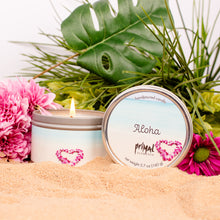 Load image into Gallery viewer, Candle with &#39;Aloha&#39; label and pink flowers on sand