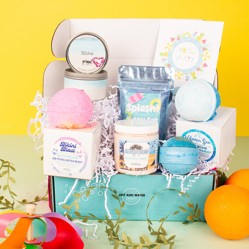 Bath product set with bath bombs, candles, and soaps on a yellow background