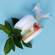 Load image into Gallery viewer, Jar of Mango Hawaiian cream with leaves on a blue background