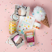 Load image into Gallery viewer, Collection of bath products and a bath bomb on a pink background with ice cream-themed packaging.
