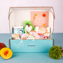 Load image into Gallery viewer, Blue box with bath bombs, soaps, and other products on a blue surface with a white background