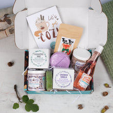 Load image into Gallery viewer, Gift box with bath products and a card on a wooden surface