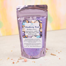 Load image into Gallery viewer, A package of BLACKBERRY TREAT BUBBLE SALT by Two Wild Hares, featuring a colorful design with bath bubbles and blackberries, placed on a surface with confetti scattered around.